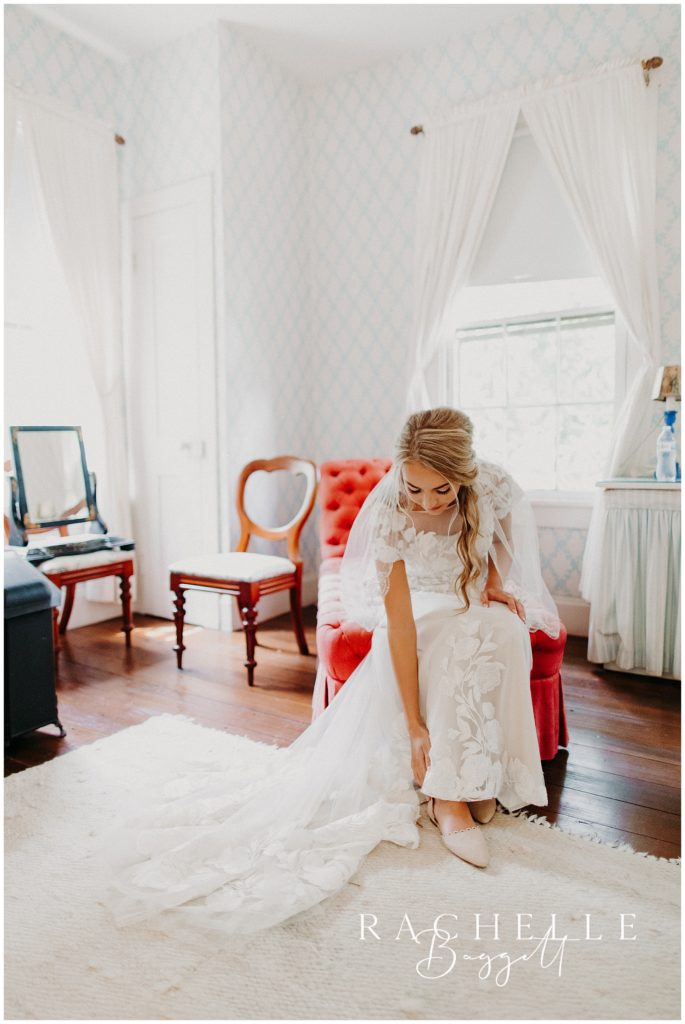 bride sits and puts on shoes