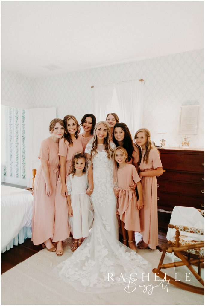bride is surrounded by her bridesmaids