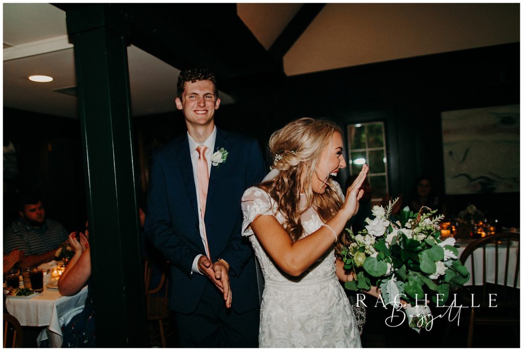 bride and groom wave at their guests