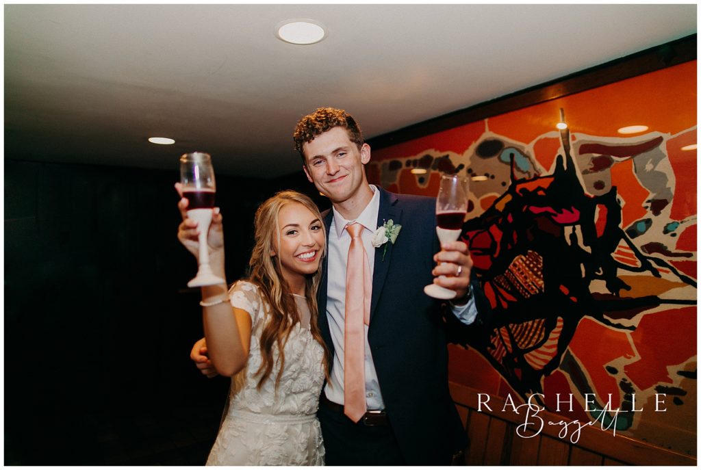 bride and groom toast with glasses