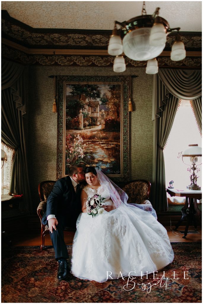 bride and groom sit on a couch