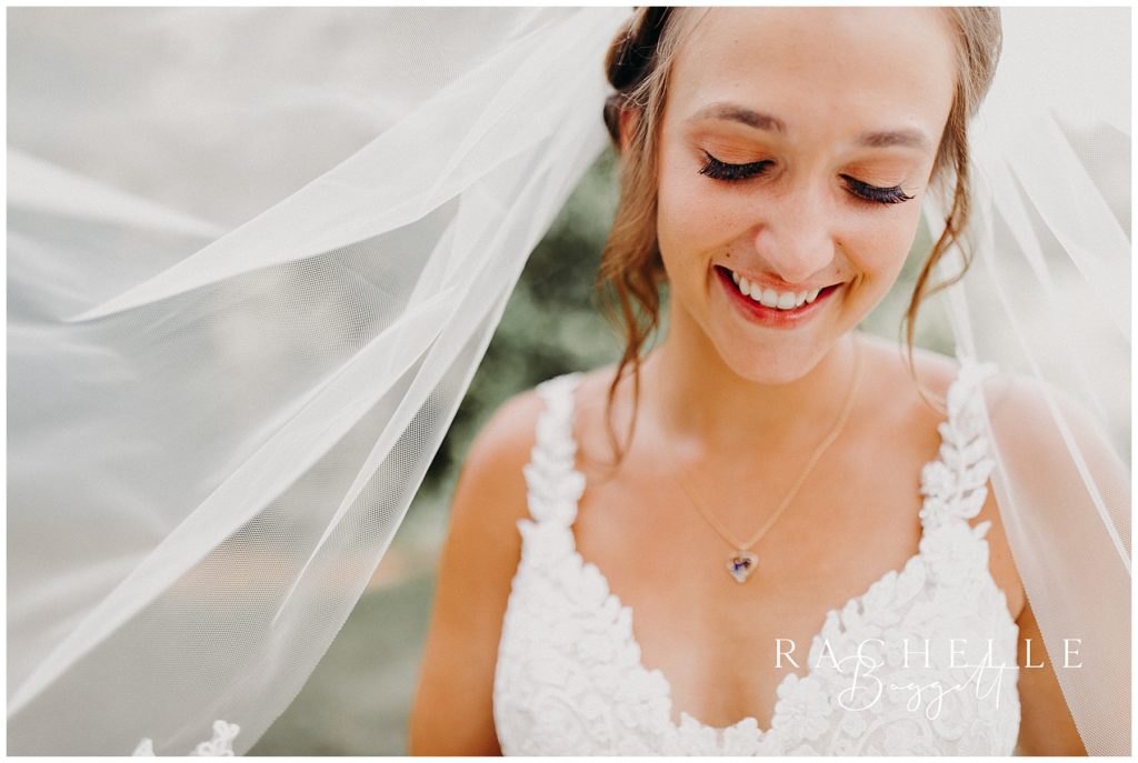 a bride smiles under her veil