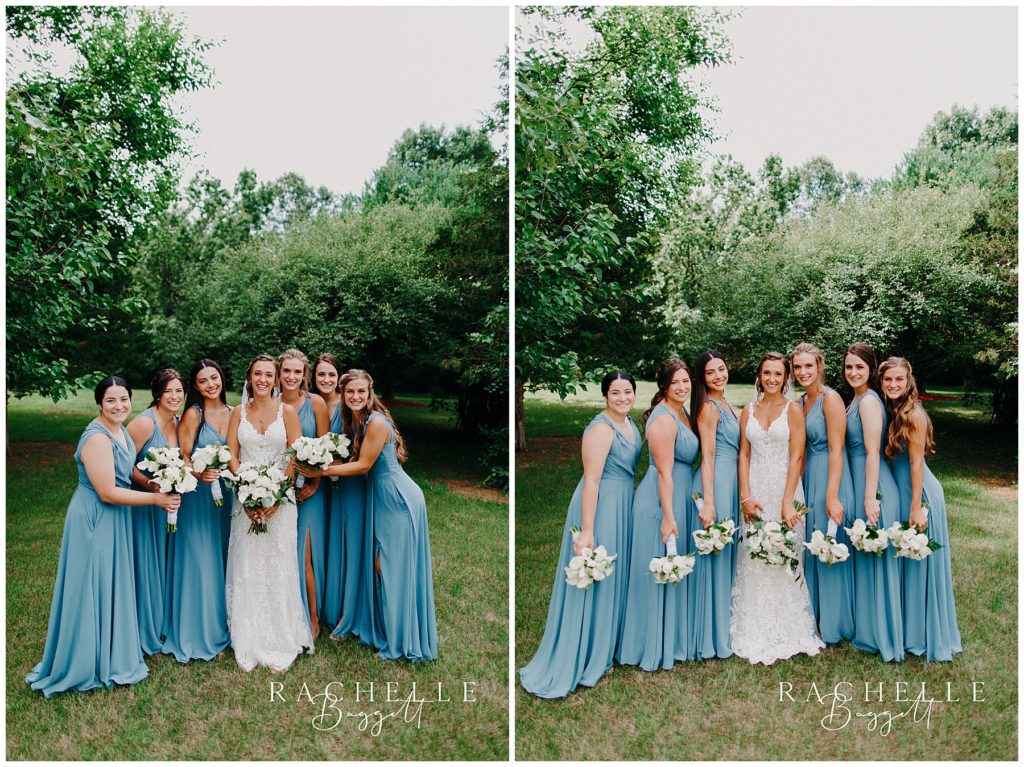 a bride and bridesmaids stand and smile in a field