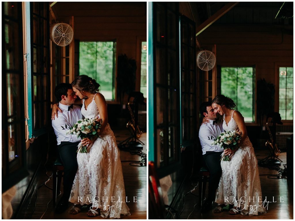 a bride and groom sit by a window at camp tamarack in brighton, michigan