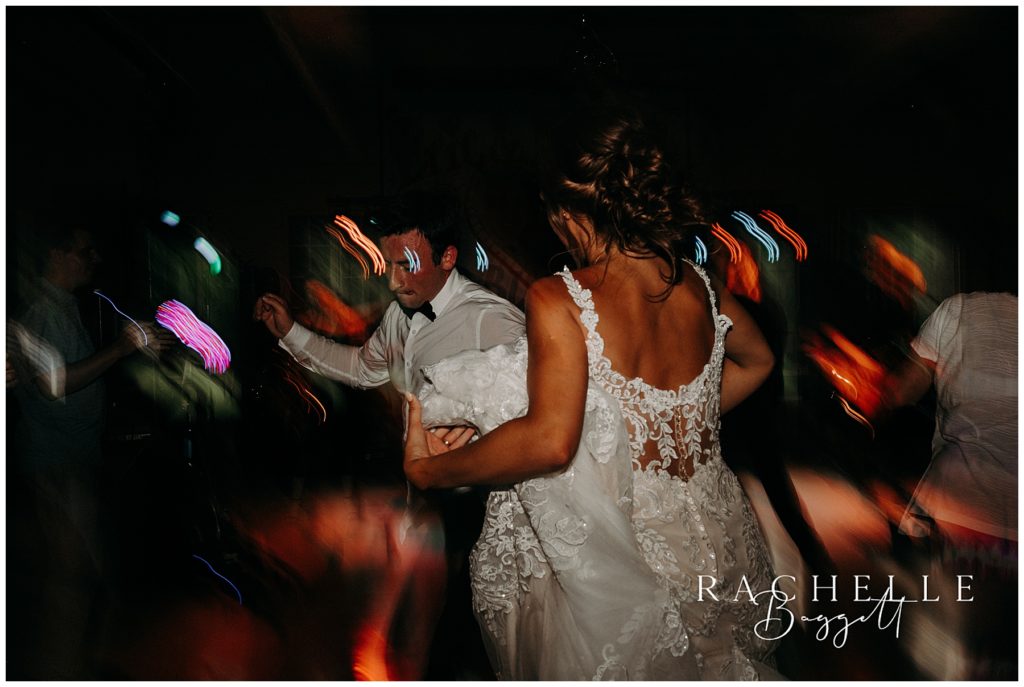 a bride and groom dance at camp tamarack in brighton michigan