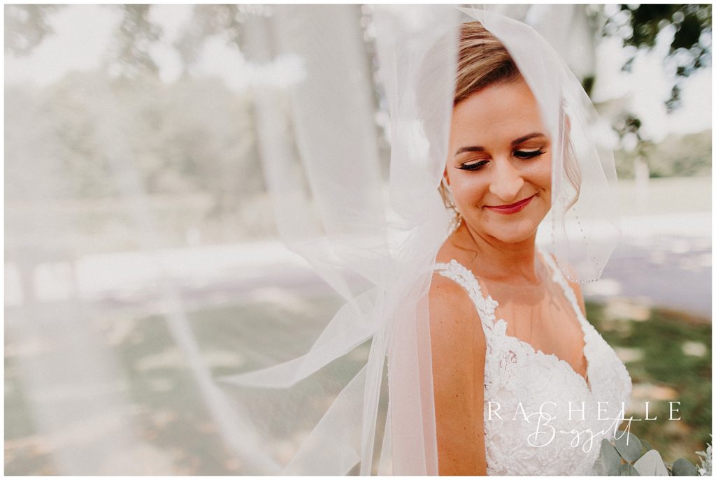 a bride smiles under her veil. Evansville Wedding Photographer.