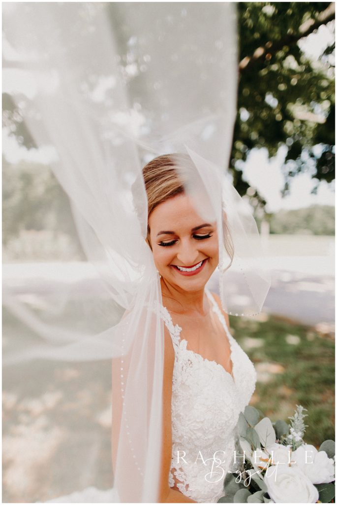 a bride smiles under her veil. Evansville Wedding Photographer.
