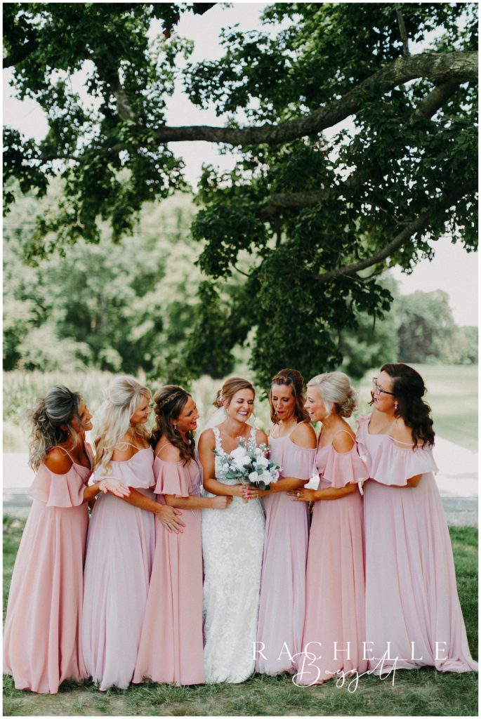 a bride and her bridesmaids look at each other. Evansville Wedding Photographer.