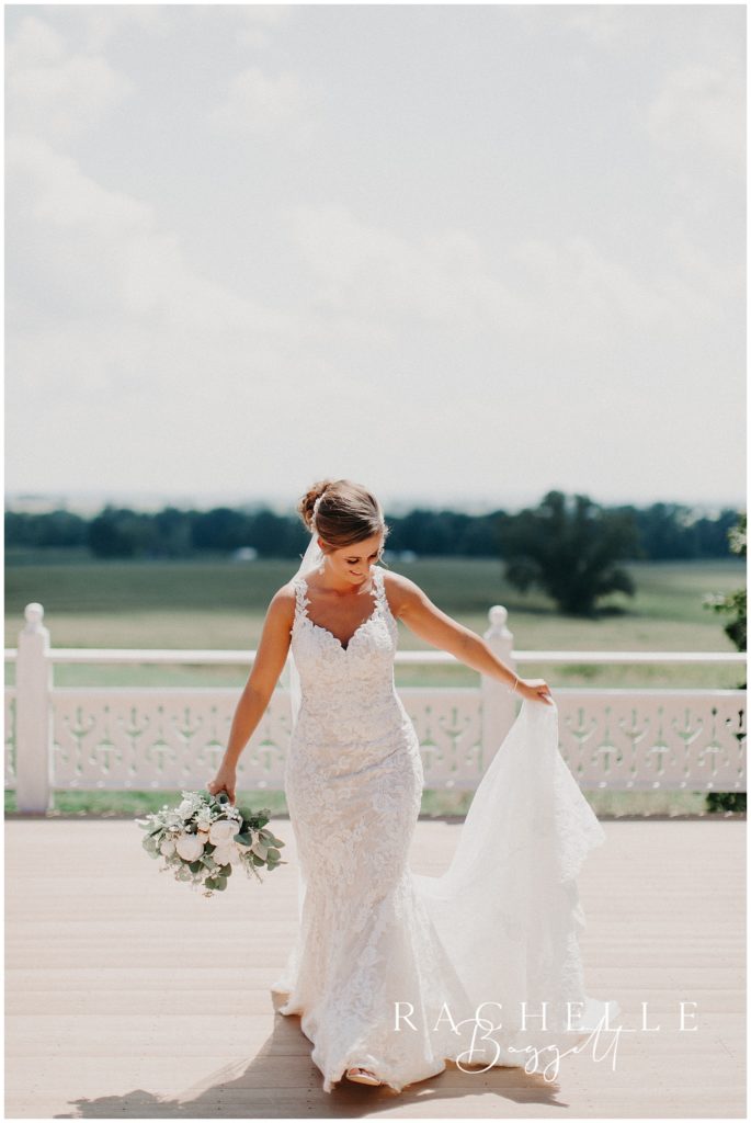 a bride holds her dress . Evansville Wedding Photographer.