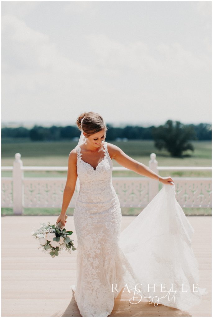a bride holds her dress. Evansville Wedding Photographer.