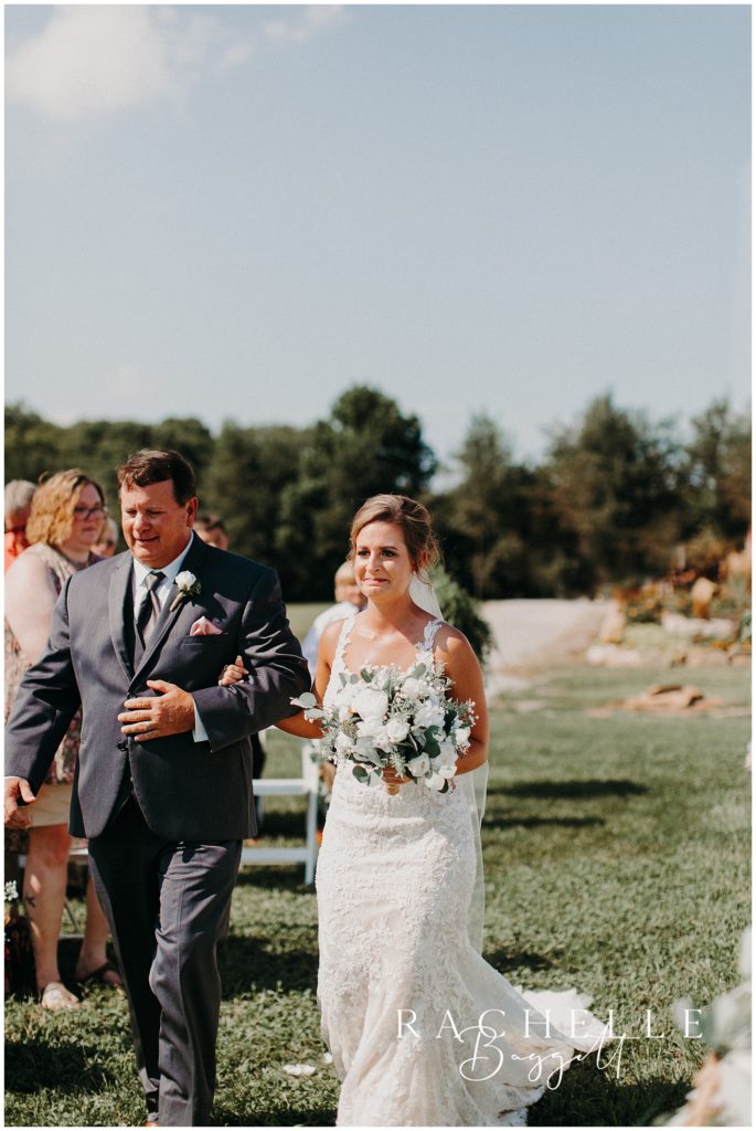 a bride and her father walk down the aisle. Evansville Wedding Photographer.