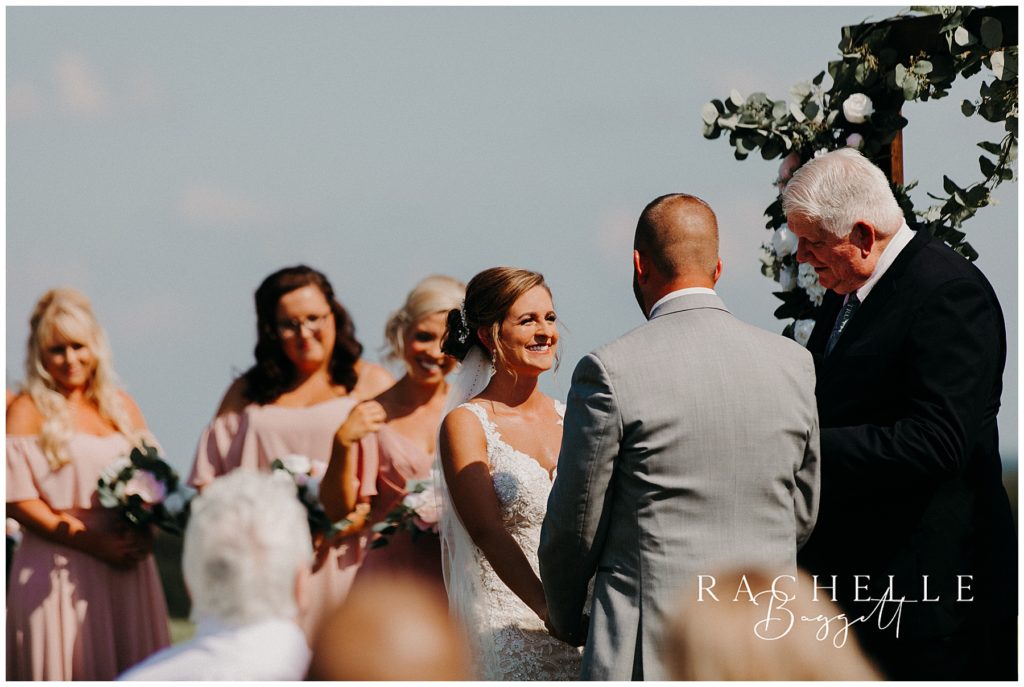 a bride laughs at the altar. Evansville Wedding Photographer.