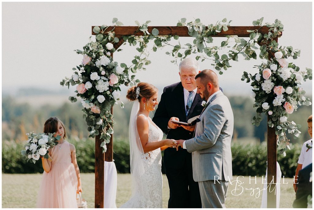 a bride and groom stand at the altar. Evansville Wedding Photographer.
