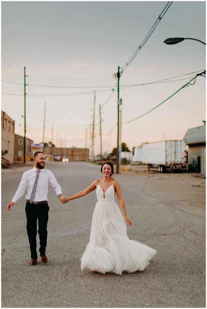 The bride and groom walking outside together| wedding photography