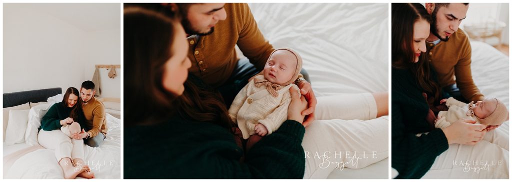 man and woman look lovingly at their new daughter, newborn photography session