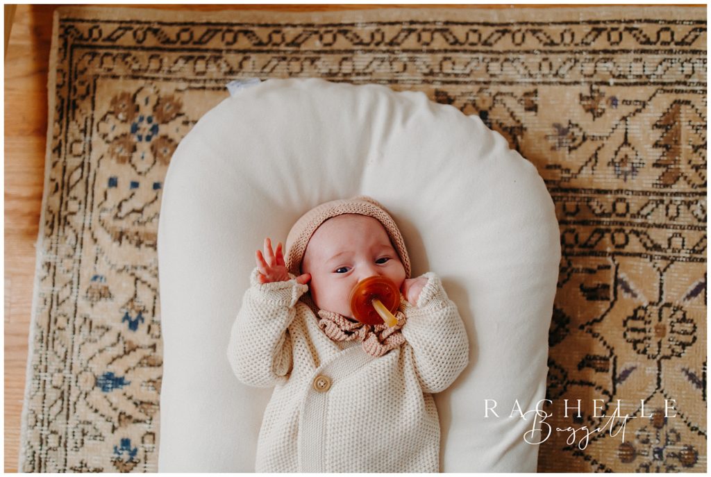 newborn baby girl with pacifier, cozy in-home family session