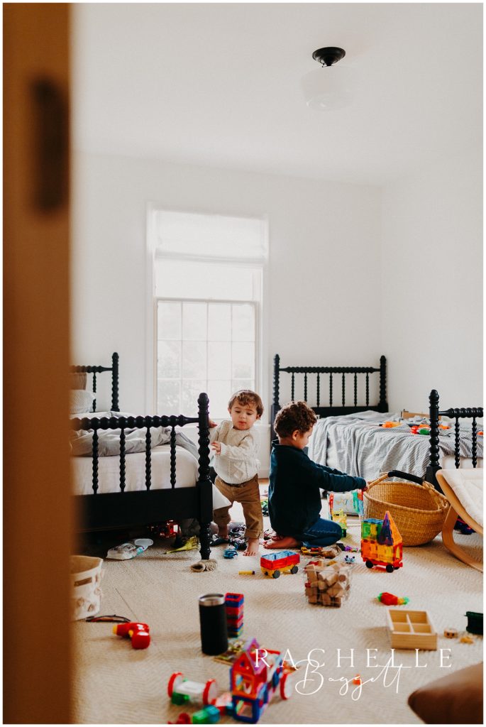 two young brothers playing in their room with toys