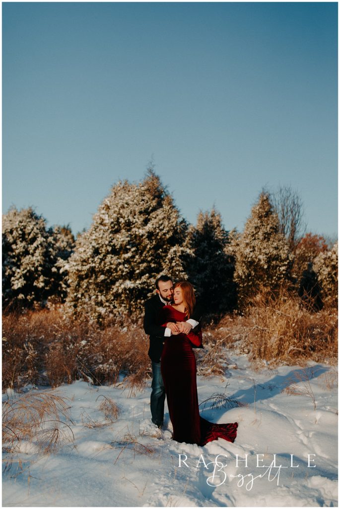 man and woman cozy up together during engagement session