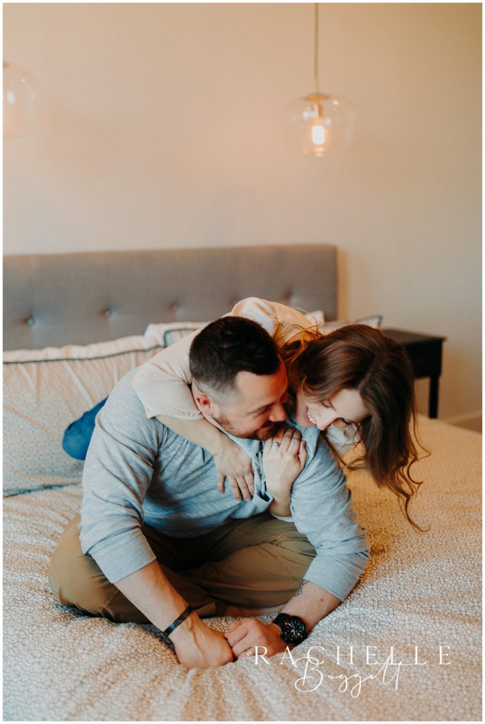 man and woman laughing and cuddling together