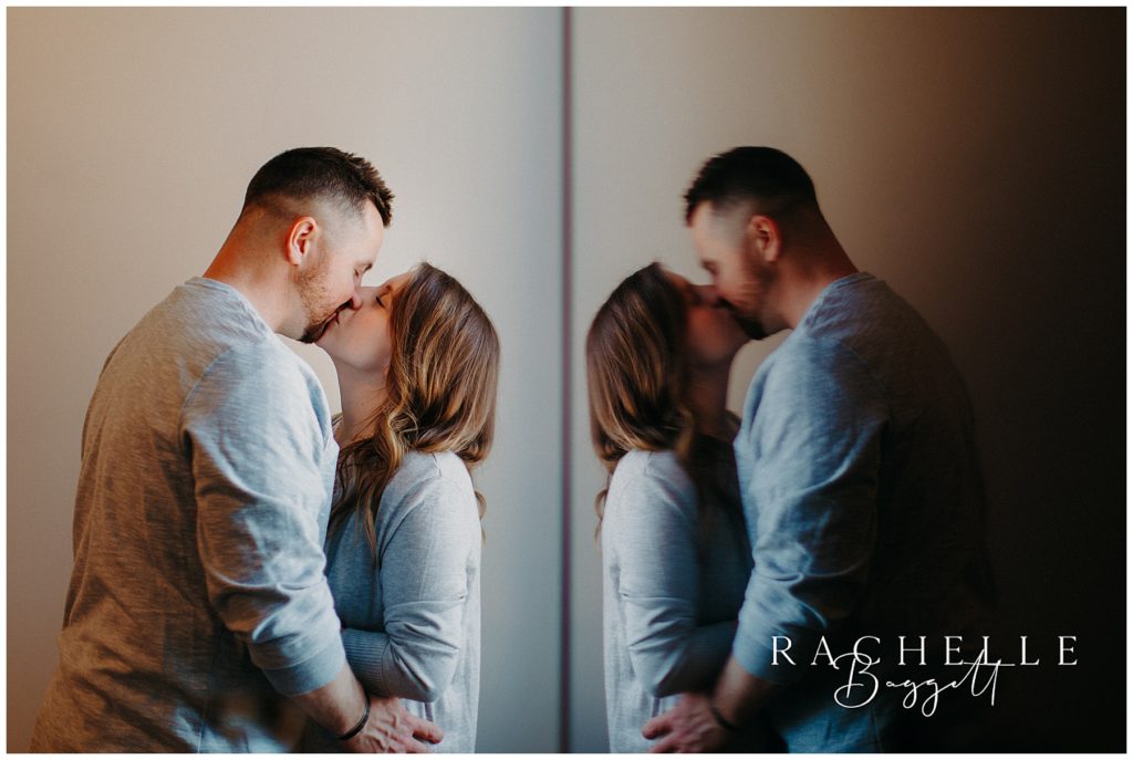 reflective photo of husband and wife kissing during Downtown Loft Couples Session