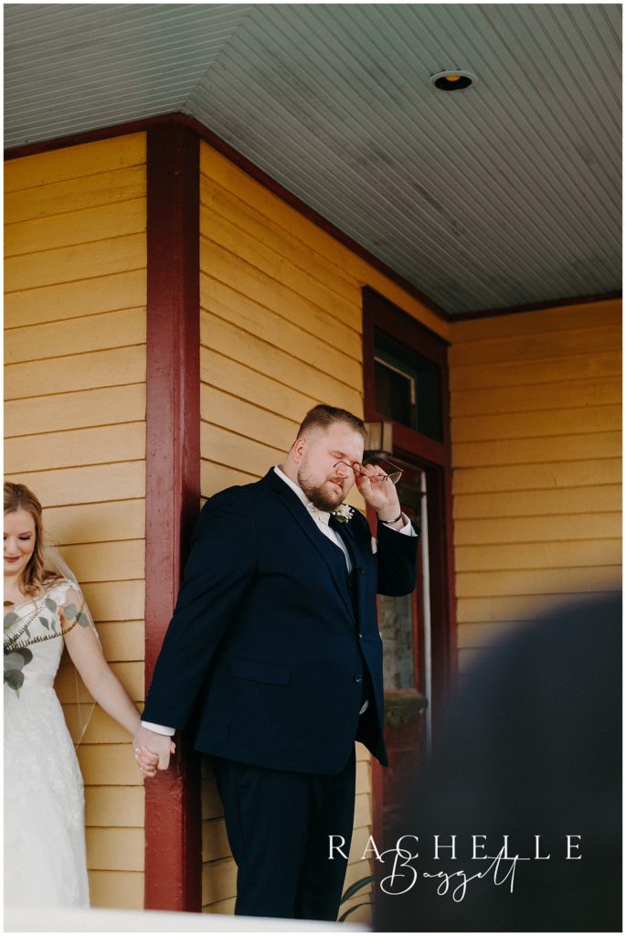 groom tearing up before wedding