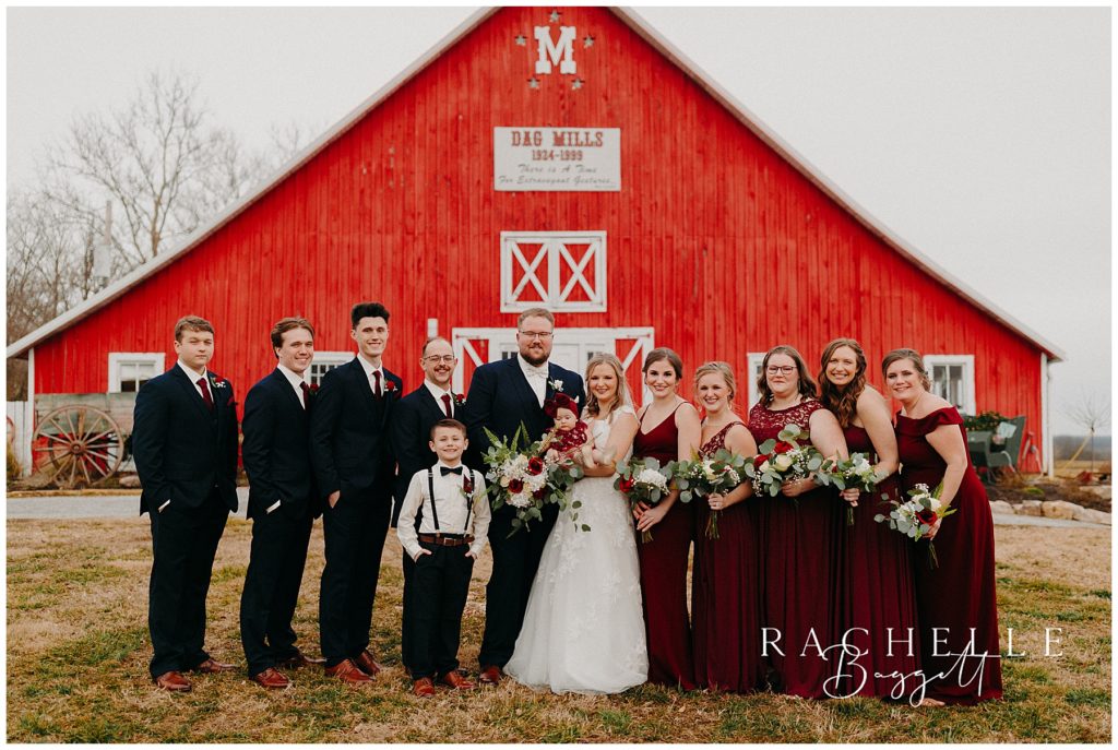 family wedding photos by the red barn outside