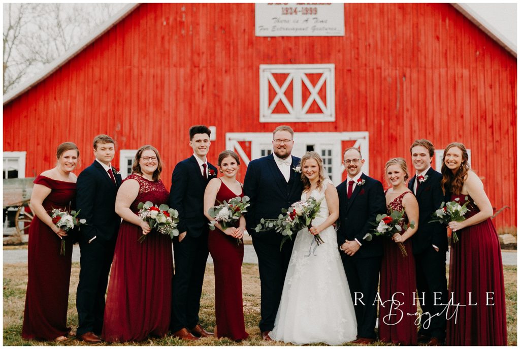 bridal party photos outside red barn