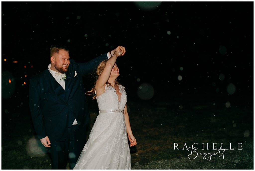bride and groom dance in snow after intimate wedding