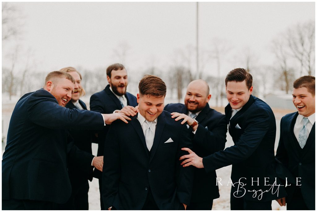 groomsmen congratulating groom