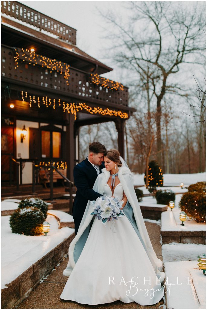 groom wraps arms around new wife at elpers snowy wedding