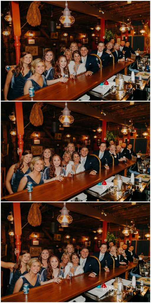 wedding party photo at the bar at the log inn