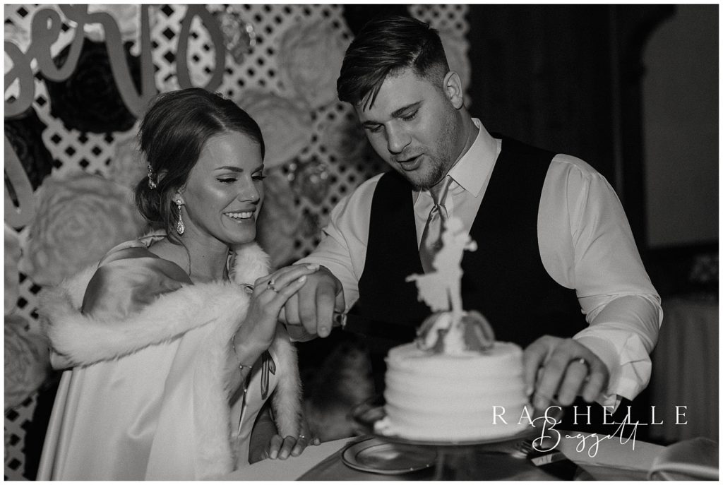 husband and wife cut cake together