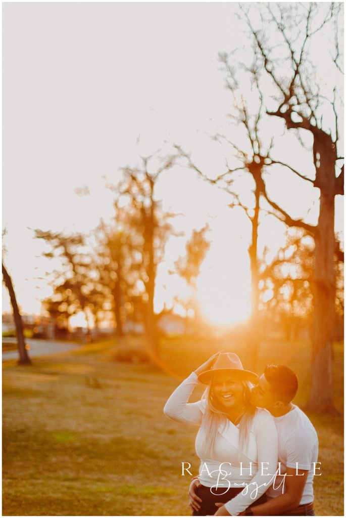 sunset glowy engagement session photo of couple laughing together