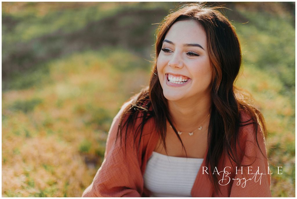teen girl smiling on the lawn during rivertown trail senior session