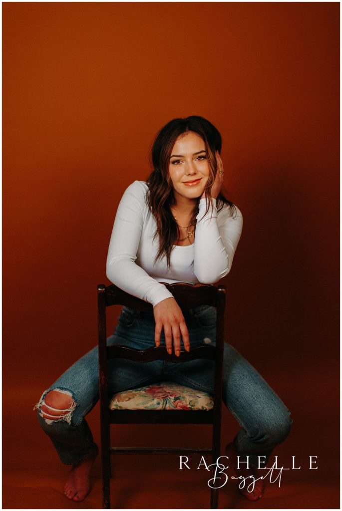 senior girl posing in vintage chair