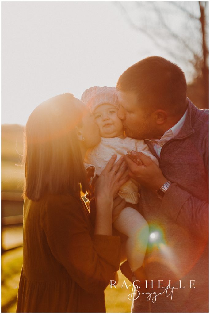 mom and dad both kiss daughter on the cheek during Sunrise Family Session
