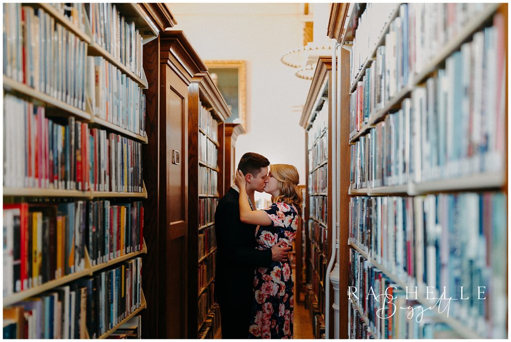 engaged couple kissing in library during Intimate Willard Library Engagement