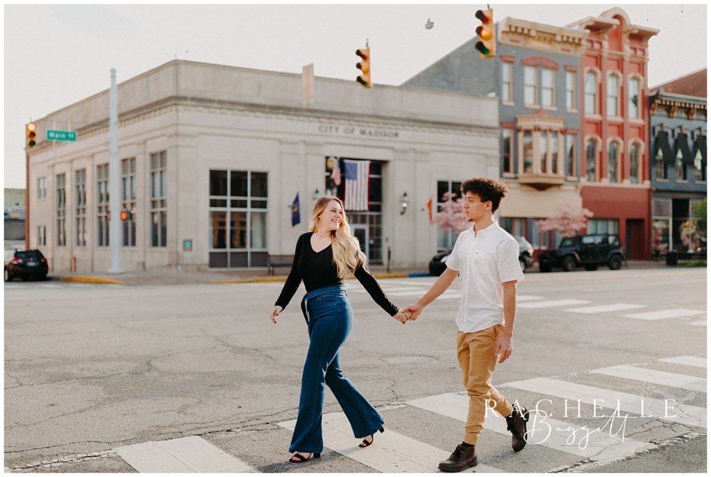 engaged couple walking downtown