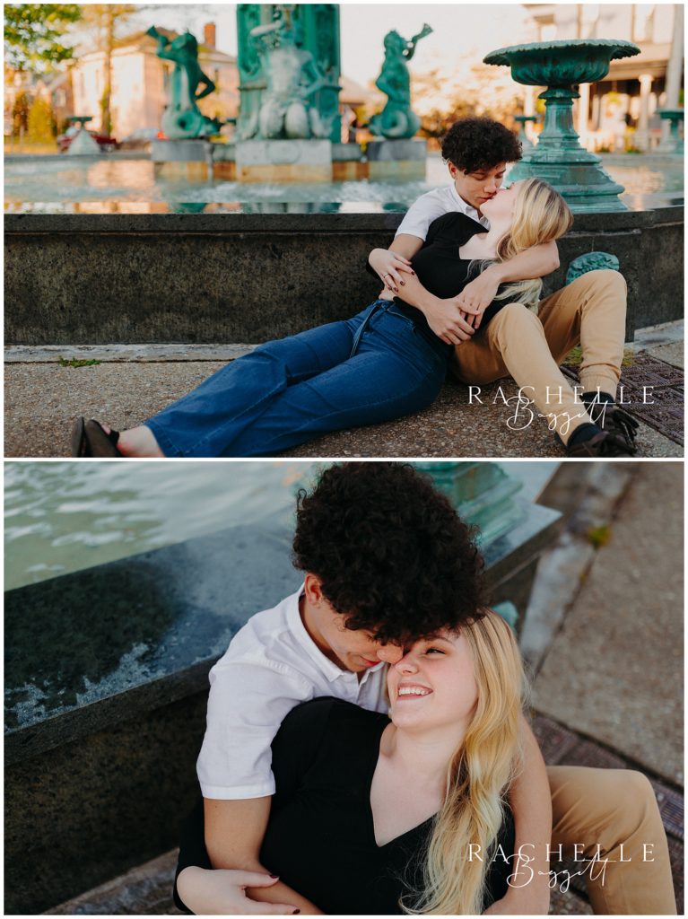 man and woman kiss by fountain during Engagement in Historic Downtown