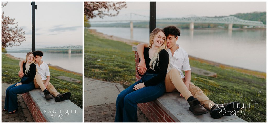 couple sits by river during Engagement in Historic Downtown