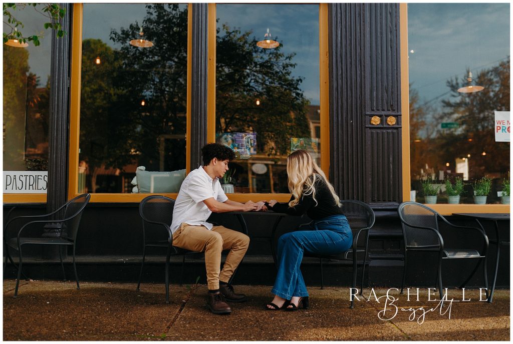 Couple sitting at outdoor cafe during Engagement in Historic Downtown