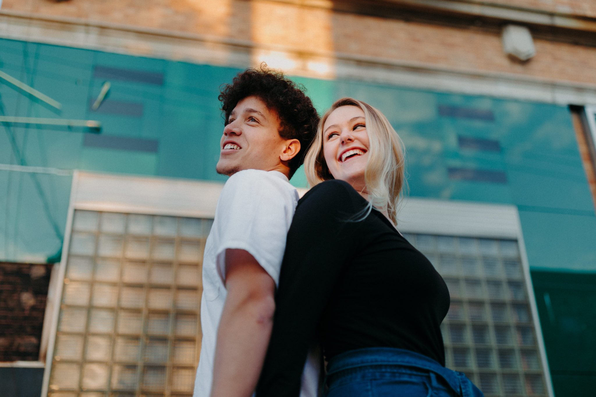 man and woman stand in front of wall