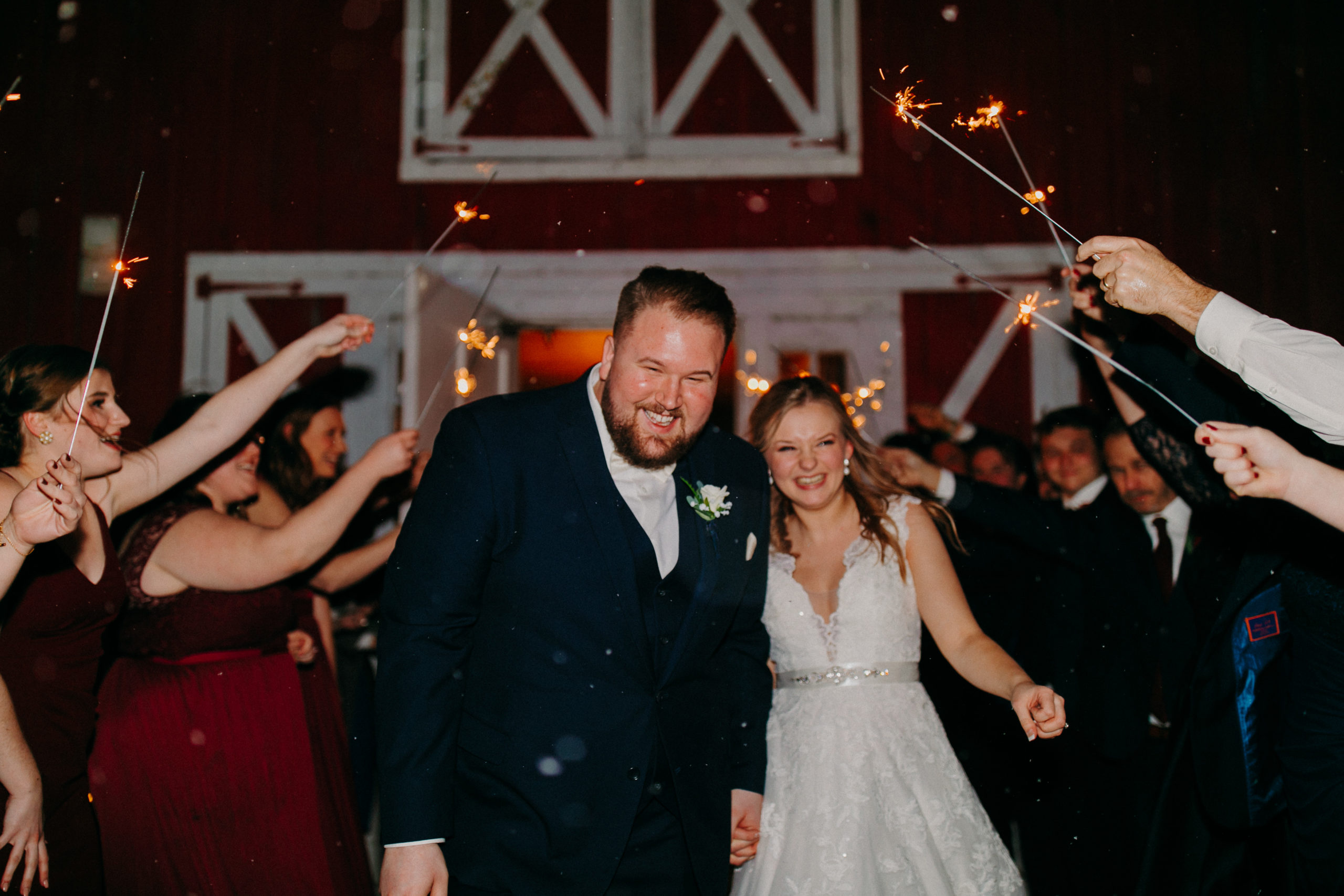 bride and groom run through sparklers
