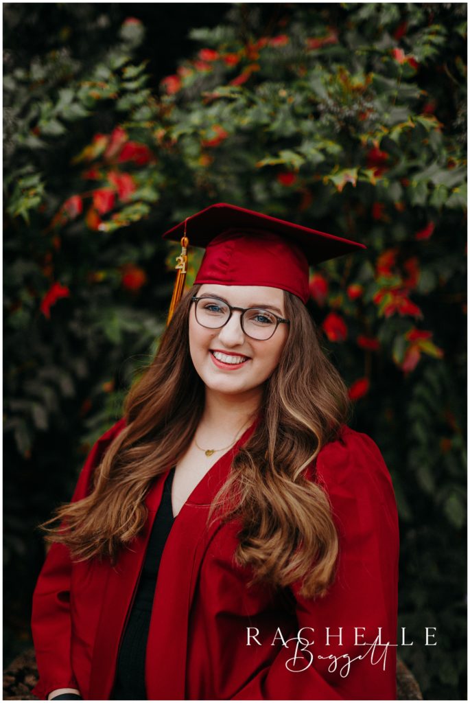 senior photo in red cap and gown