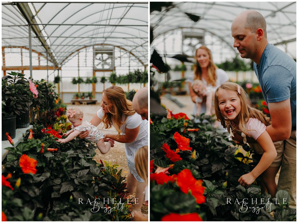 parents letting children smell the flowers in the greenhouse