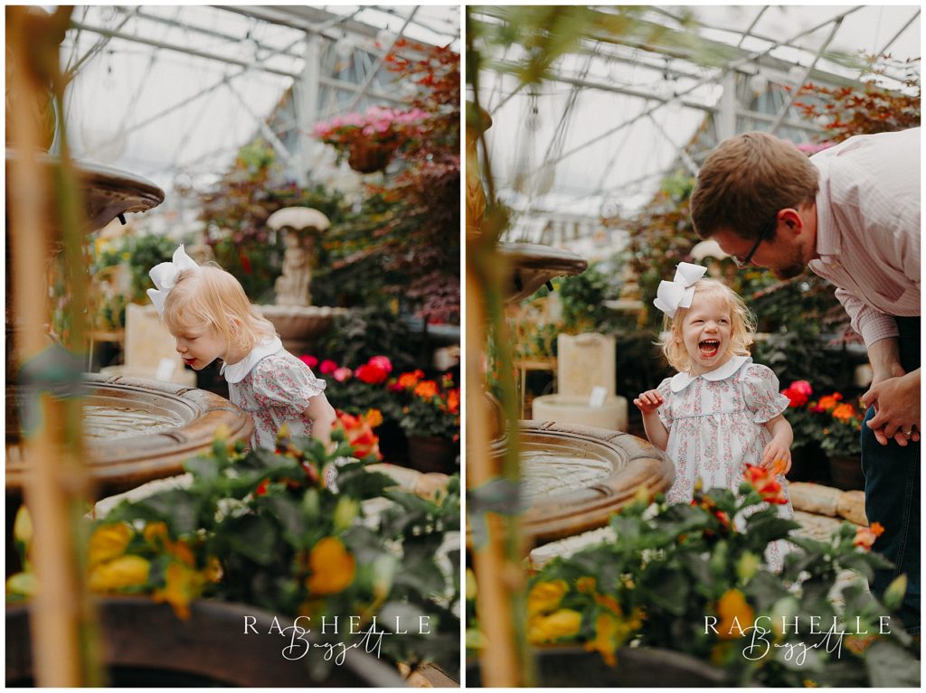 dad and daughter exploring a fountain in the greenhouse