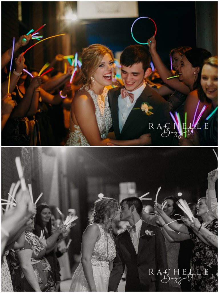 husband and wife kiss and laugh during glow stick exit during Spring Wedding at City View