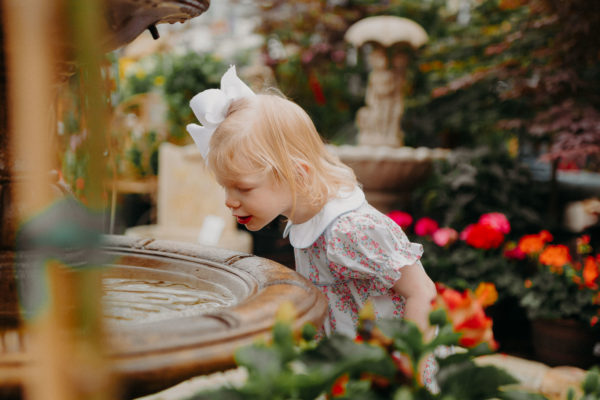 girl looks into pond