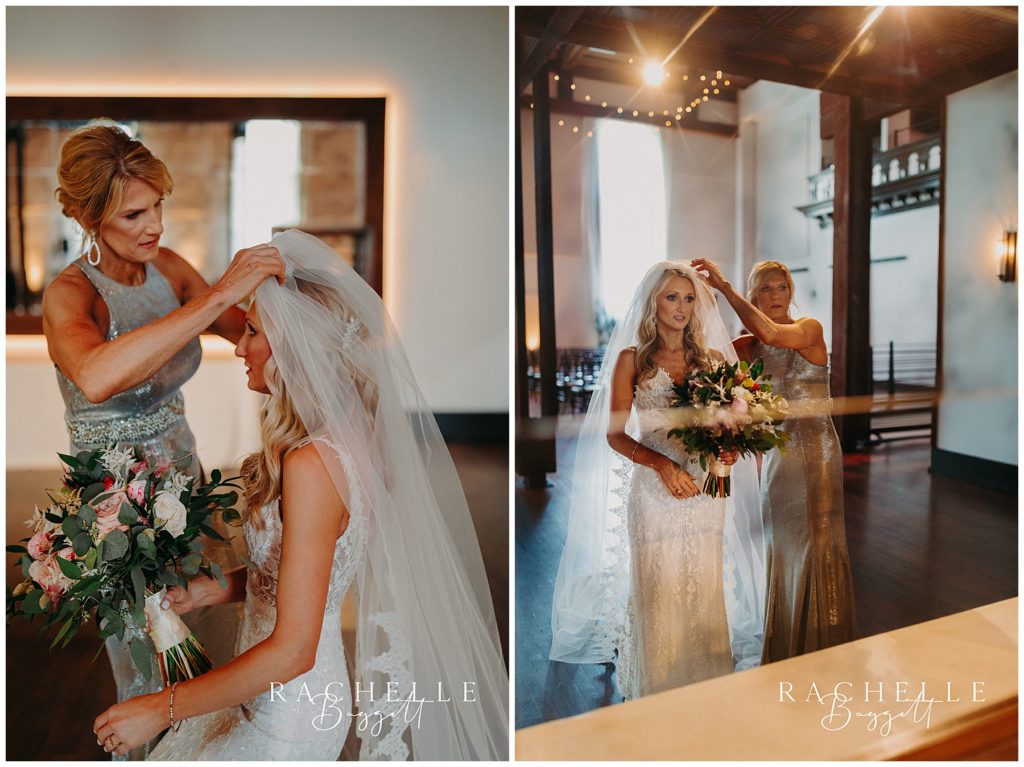 bride putting on veil with mom's help