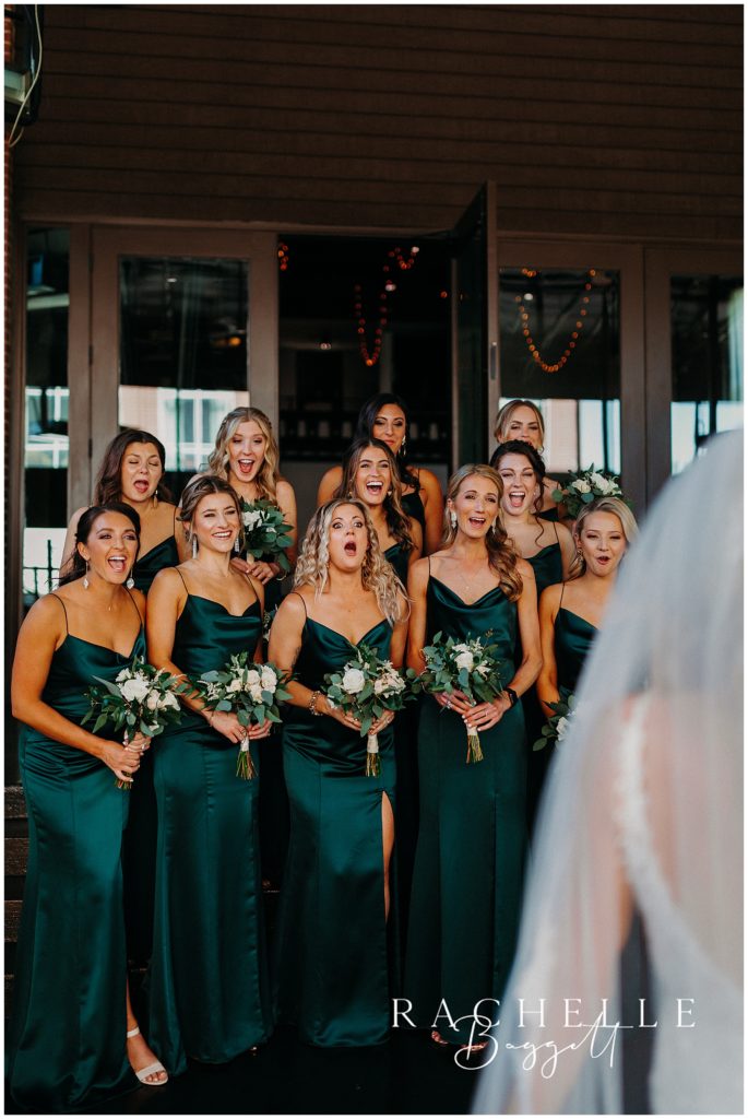 first look reaction of bridal party during May Wedding at The Bell Tower